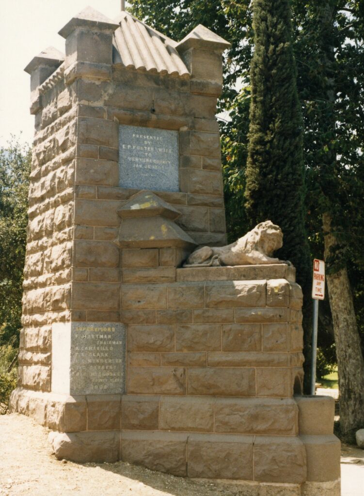 Stone entrance marker with lion statue at Foster Park.