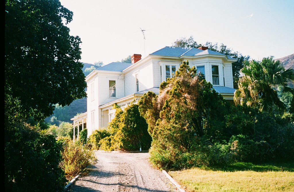 Historic two-story house surrounded by trees, Hardison House, 1985.